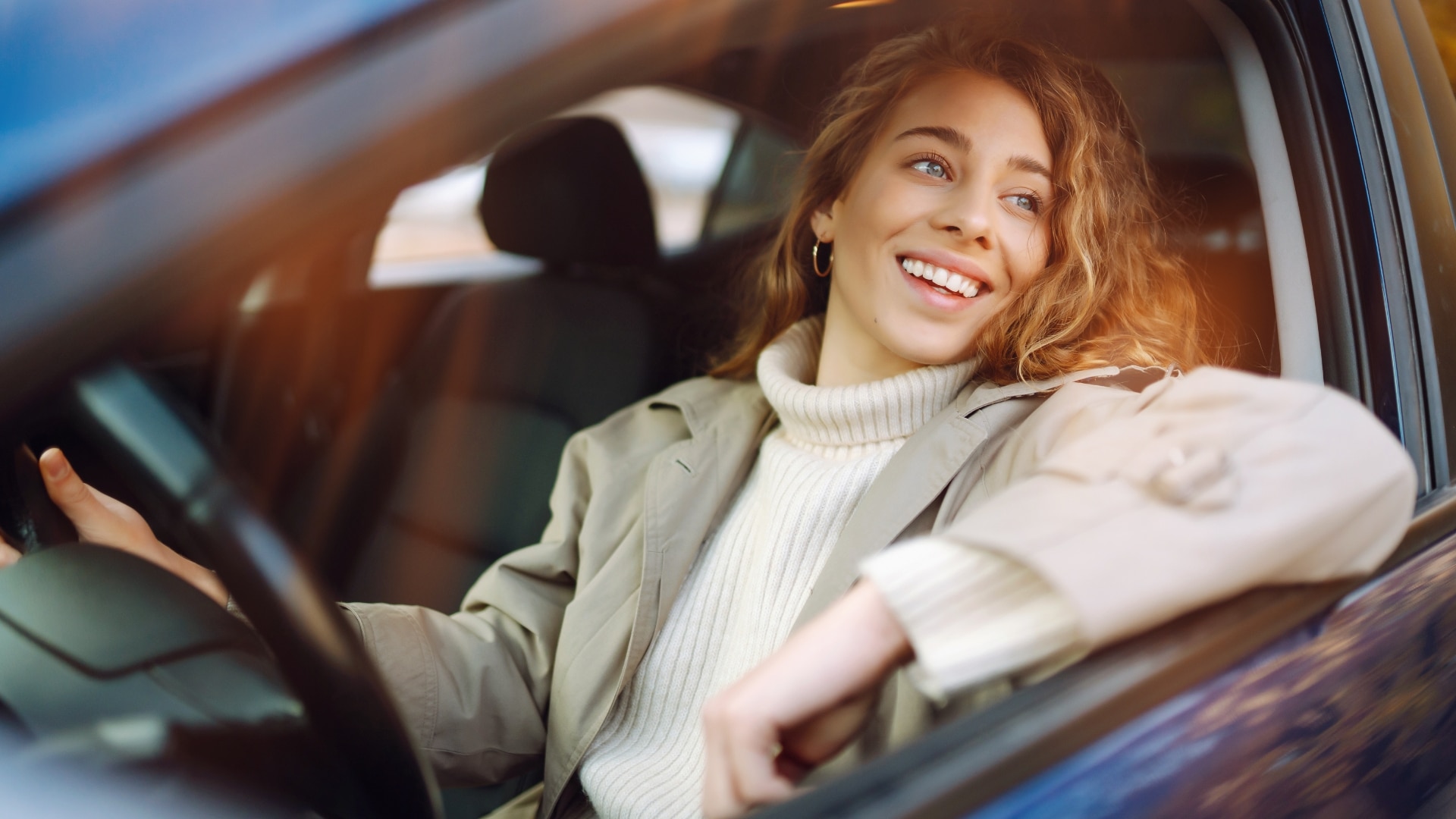 Woman smiling while preparing to get a car wash