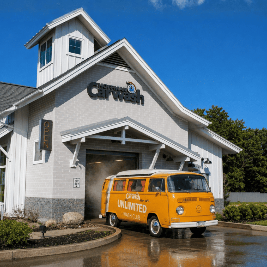 Image of an orange van exiting a car wash tunnel