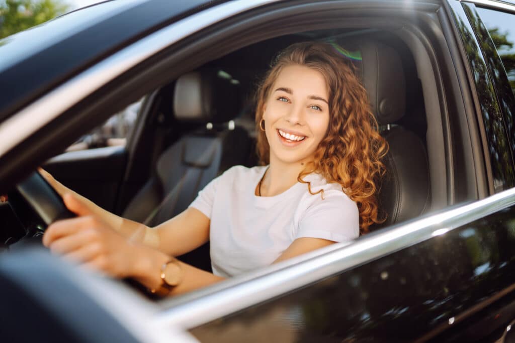 Stylish woman driving a car.
